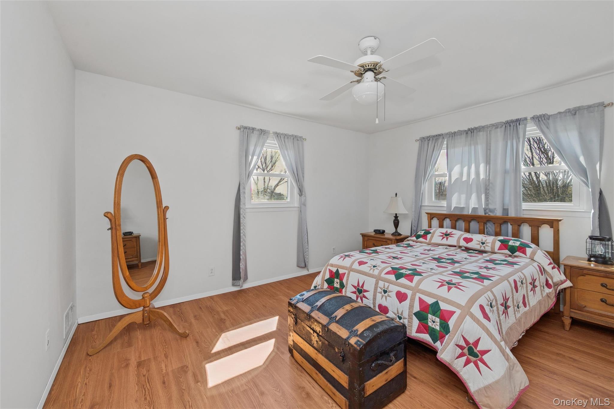 310 South 16th Street Lindenhurst, NY 11757 - Photo 12 of 23 a bedroom with a bed a chandelier and a chandelier