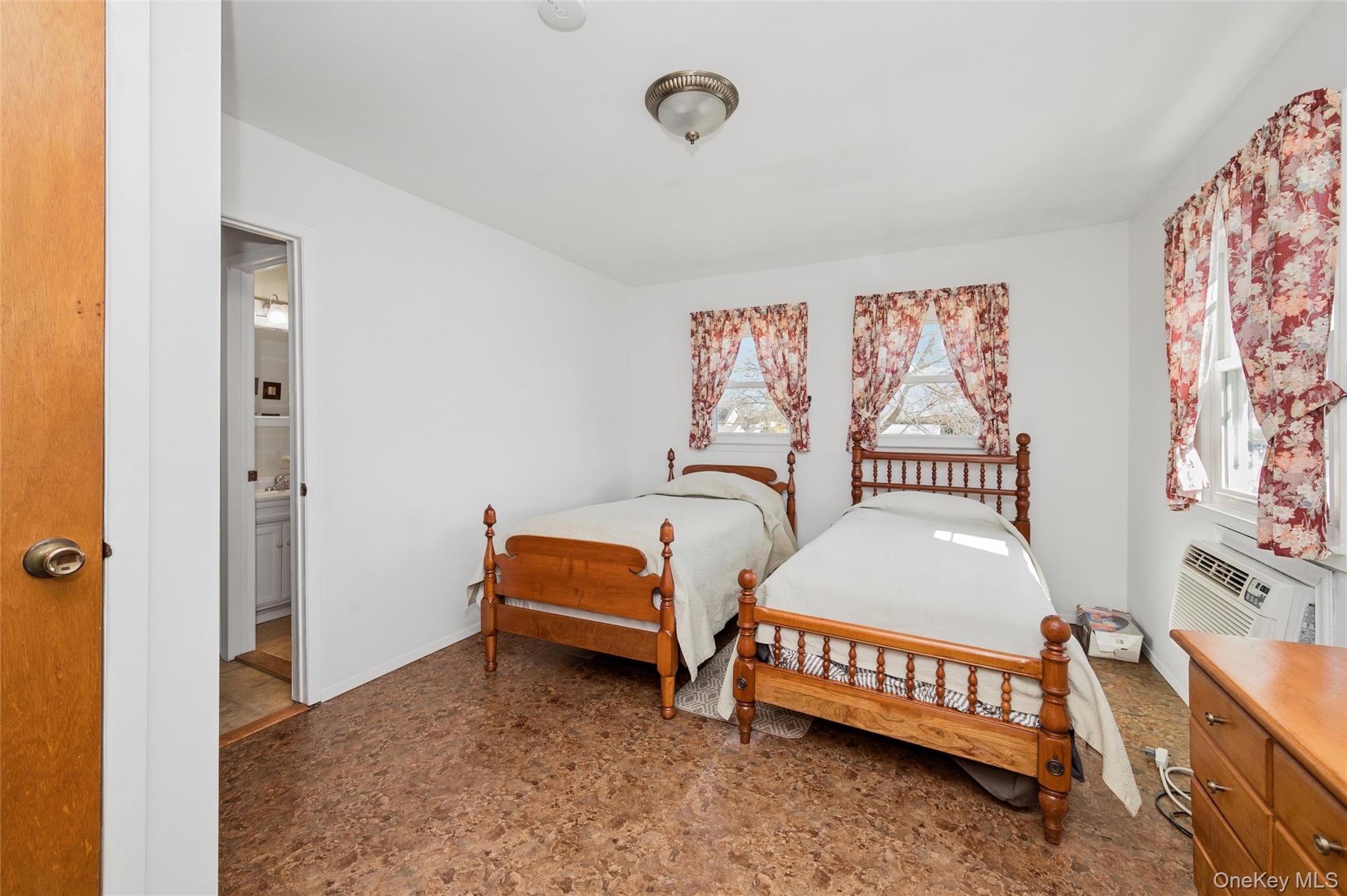 310 South 16th Street Lindenhurst, NY 11757 - Photo 13 of 23 a bedroom with a bed and a table in it