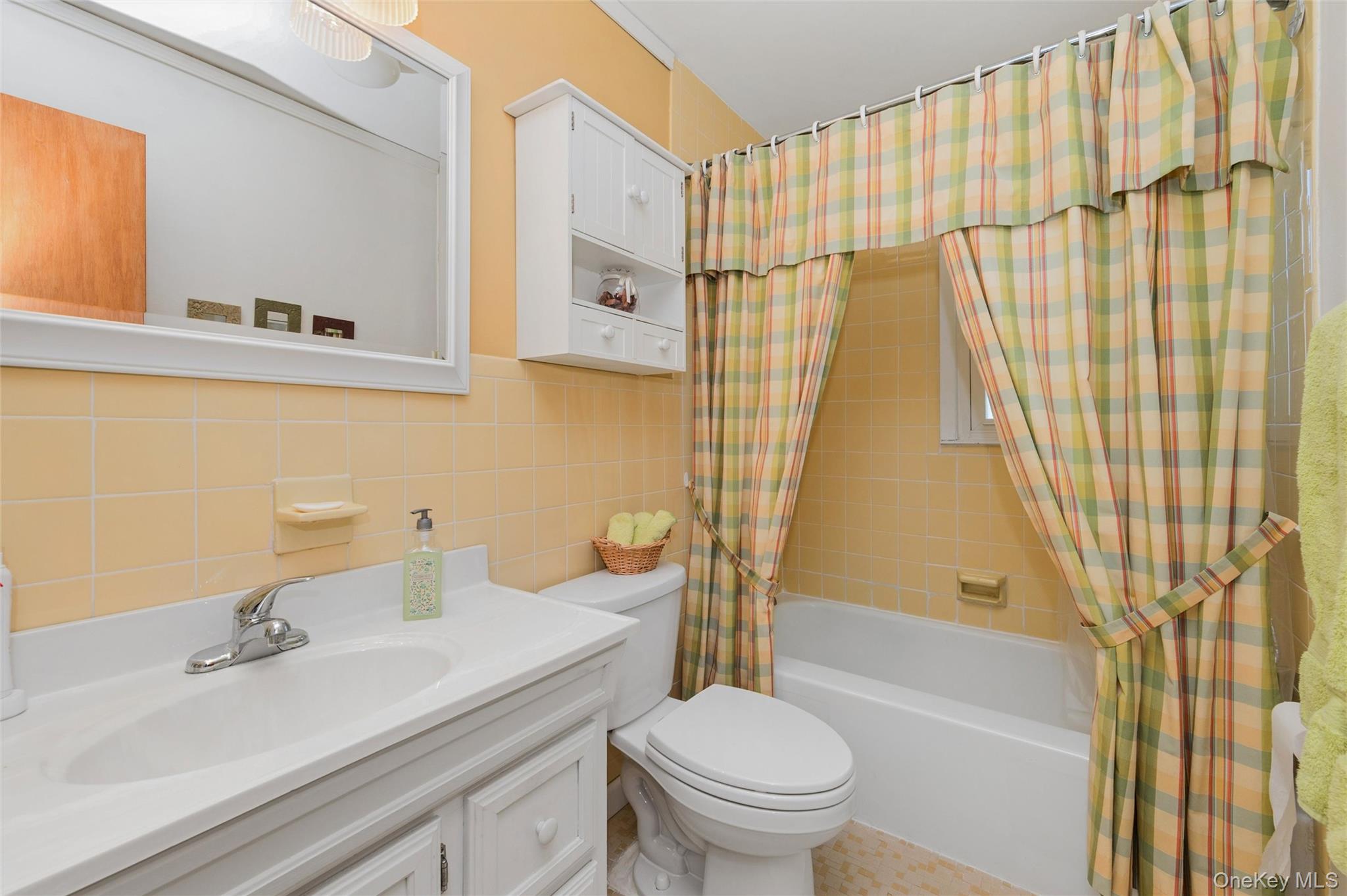 310 South 16th Street Lindenhurst, NY 11757 - Photo 14 of 23 a bathroom with a sink a toilet and a mirror