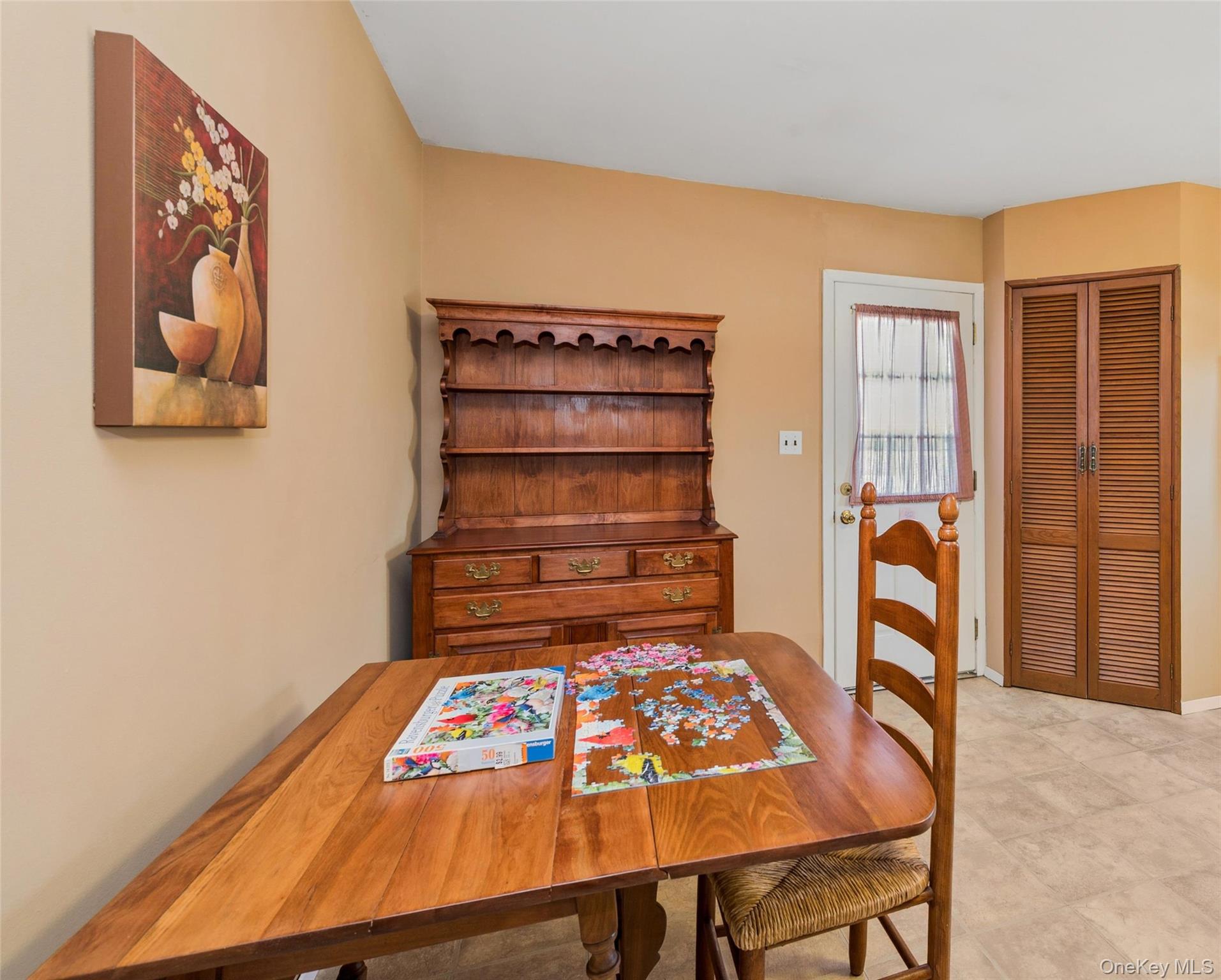 310 South 16th Street Lindenhurst, NY 11757 - Photo 15 of 23 a bedroom with a bed and a table in it