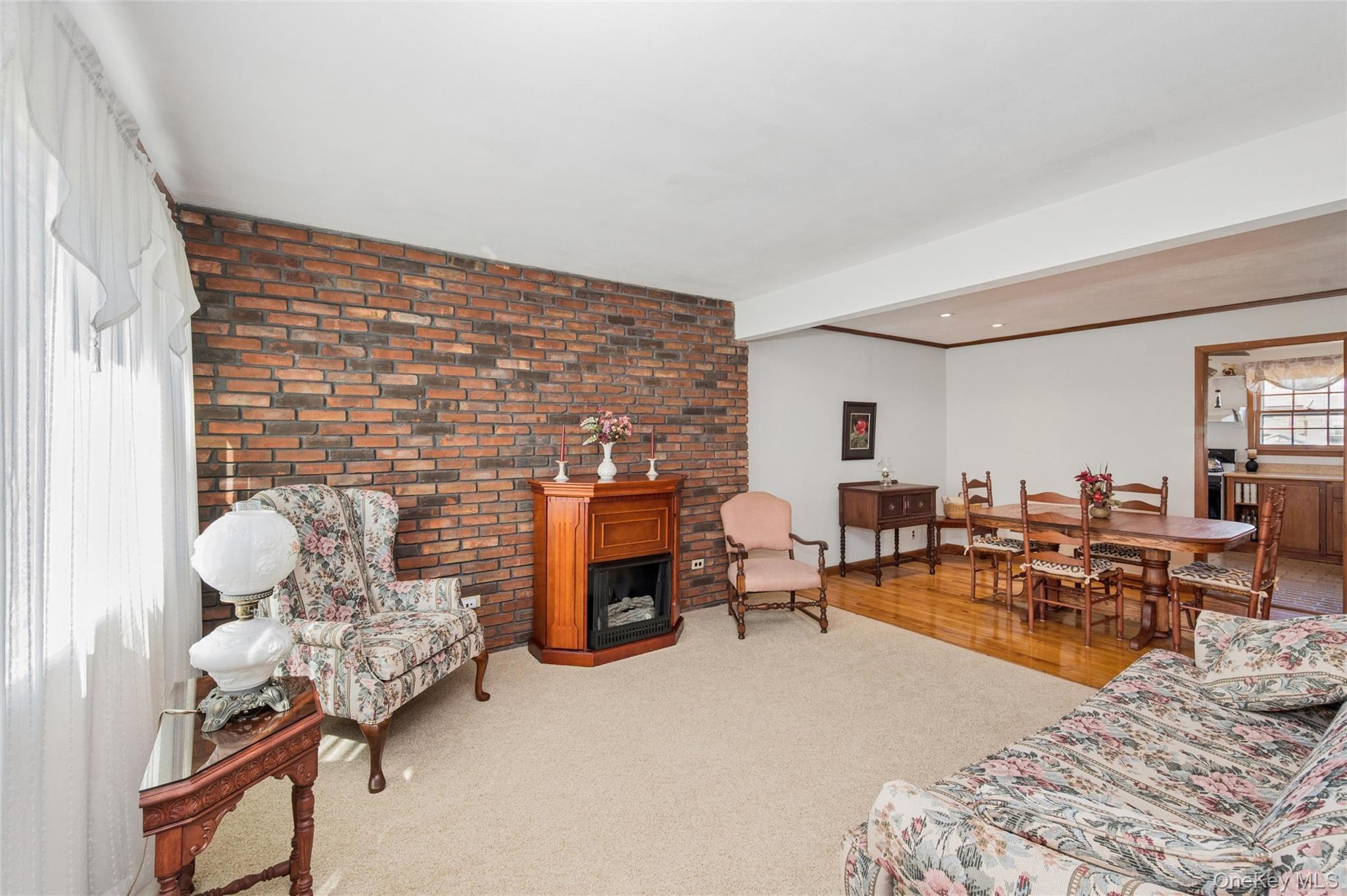 310 South 16th Street Lindenhurst, NY 11757 - Photo 19 of 23 a living room with furniture chess table and a fireplace