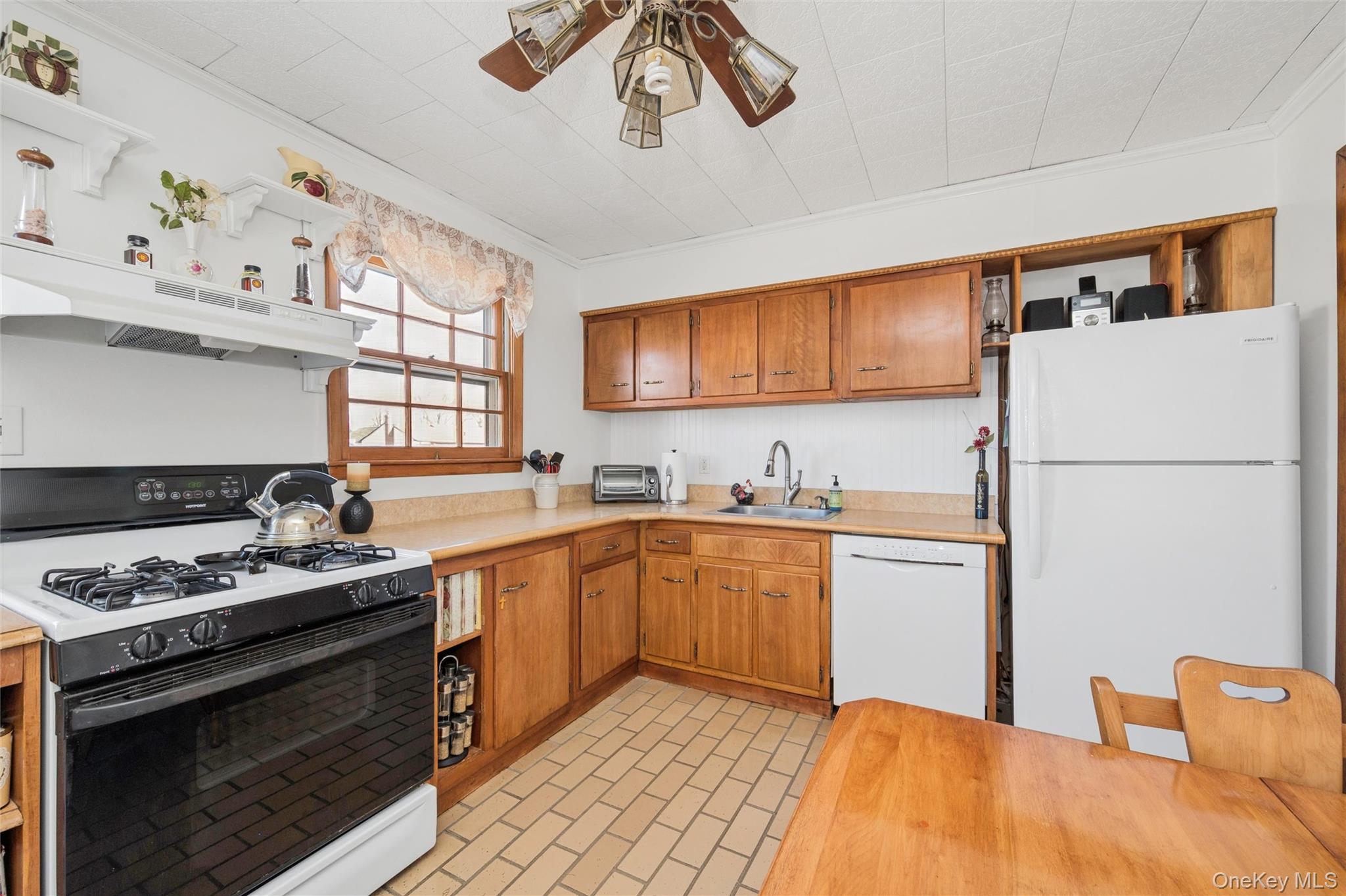 310 South 16th Street Lindenhurst, NY 11757 - Photo 4 of 23 a kitchen with stainless steel appliances granite countertop a sink stove and refrigerator
