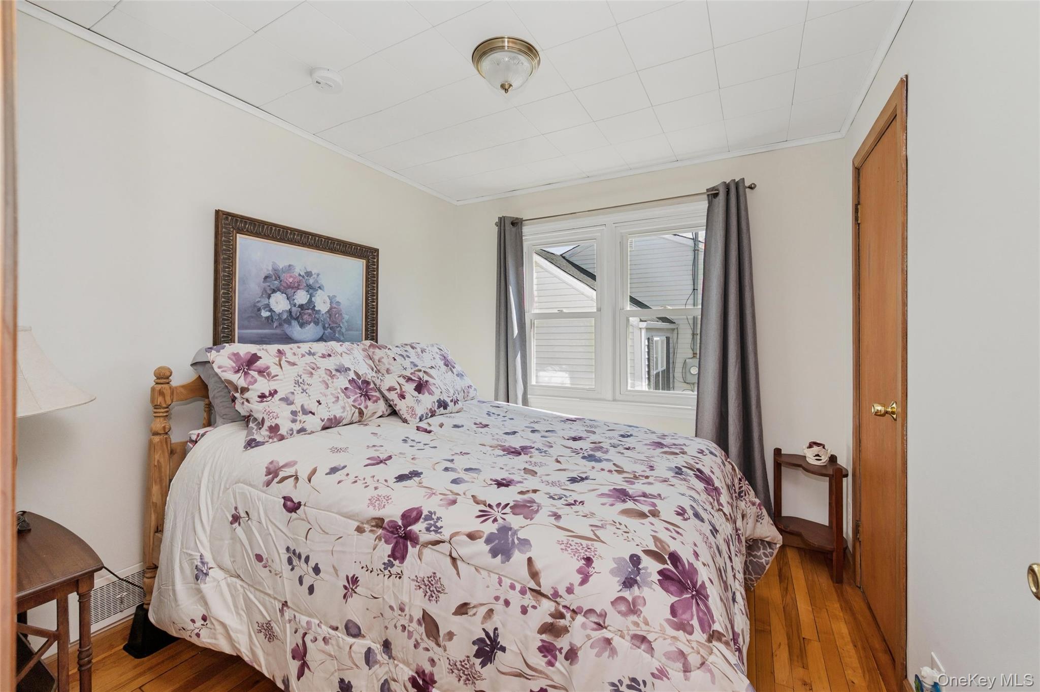 310 South 16th Street Lindenhurst, NY 11757 - Photo 6 of 23 a bedroom with a large bed and a window