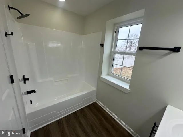 a bathroom with a bathtub and a window