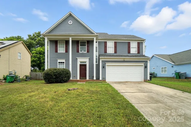 a front view of a house with a yard and garage