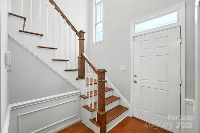 a view of entryway with wooden floor and stairs