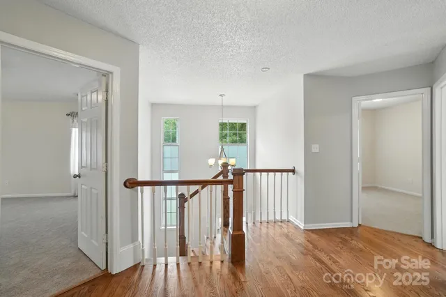 a view of hallway with wooden floor