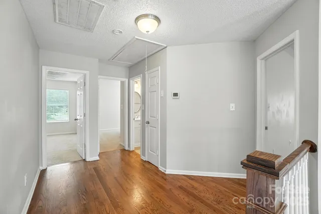 a view of an empty room and wooden floor