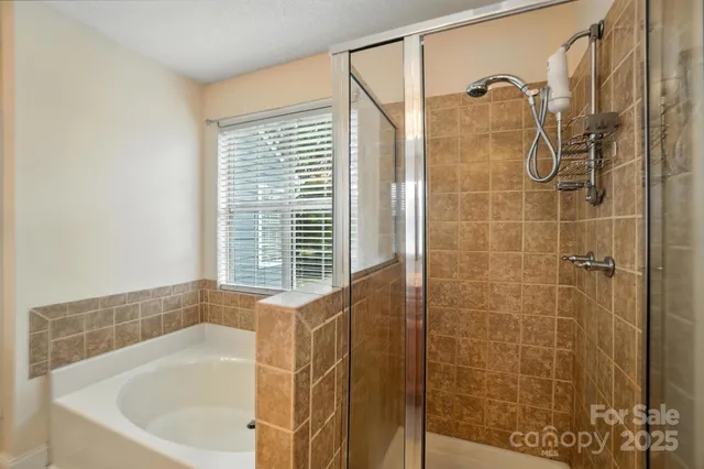 a bathroom with a bathtub and shower