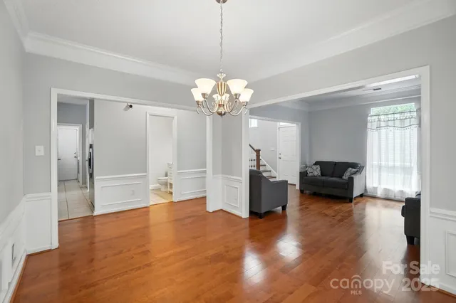 a living room with fireplace furniture and a chandelier