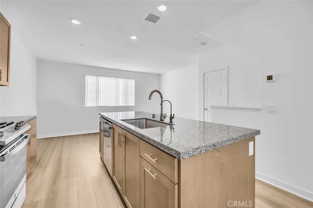 a kitchen with a sink stove and cabinets