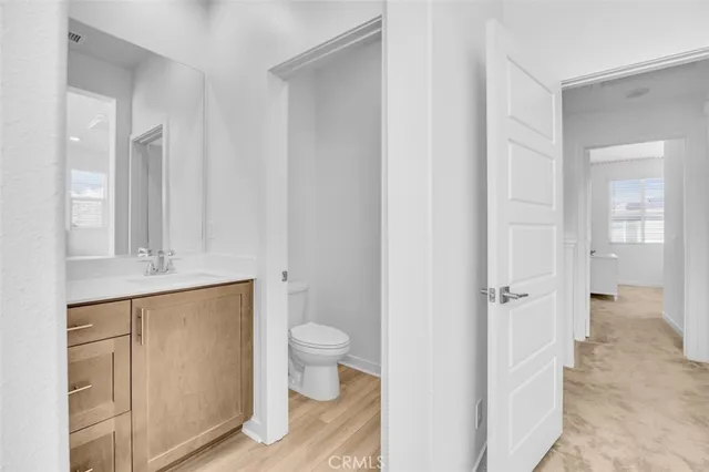 a bathroom with a toilet sink and a mirror