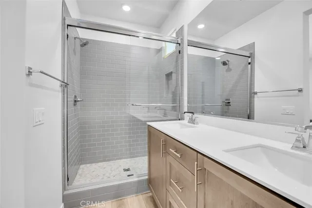 a bathroom with a sink double vanity and shower
