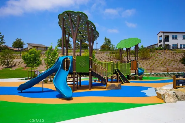 a view of a chairs and table in the patio and a fountain