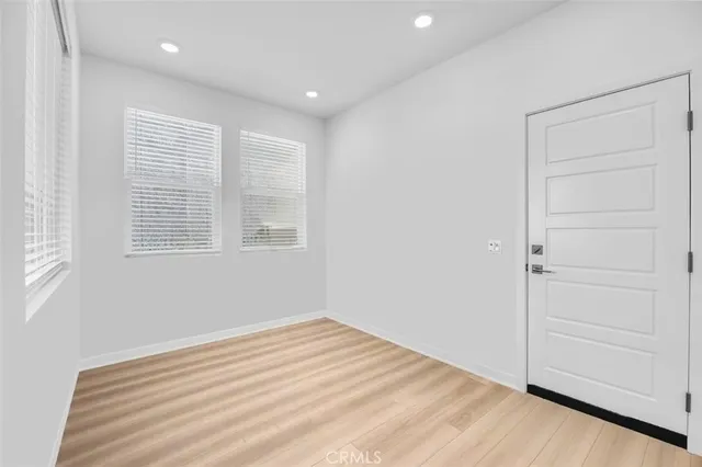 a view of a room with wooden floor and cabinet
