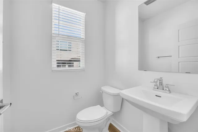 a bathroom with a sink toilet and a mirror