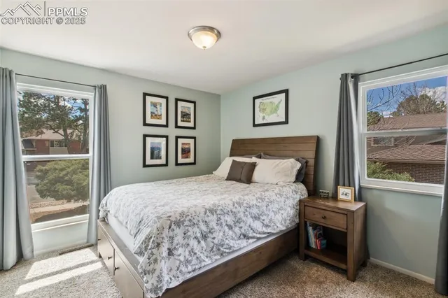a bedroom with a large bed and a window