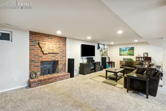 a living room with fireplace furniture and a flat screen tv