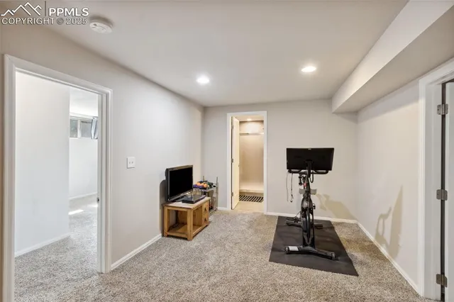a living room with furniture a window and a flat screen tv