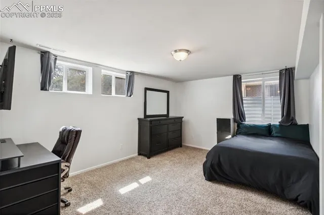 a bedroom with a bed and a desk