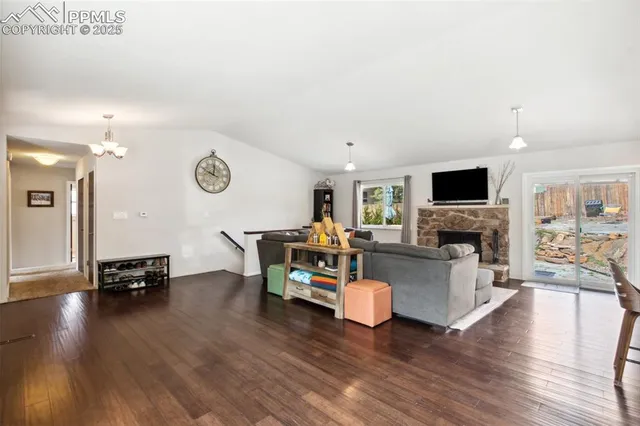 a living room with fireplace furniture and a flat screen tv