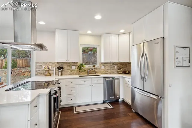 a kitchen with a refrigerator a sink and cabinets