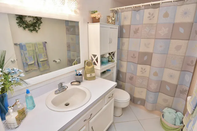 a bedroom with a bed and a mirror on dresser