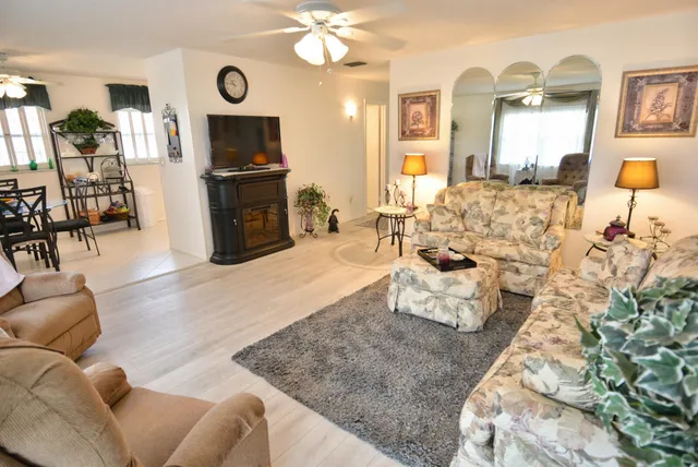 a living room with furniture and wooden floor