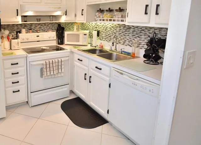 a bathroom with a double vanity sink toilet and a mirror