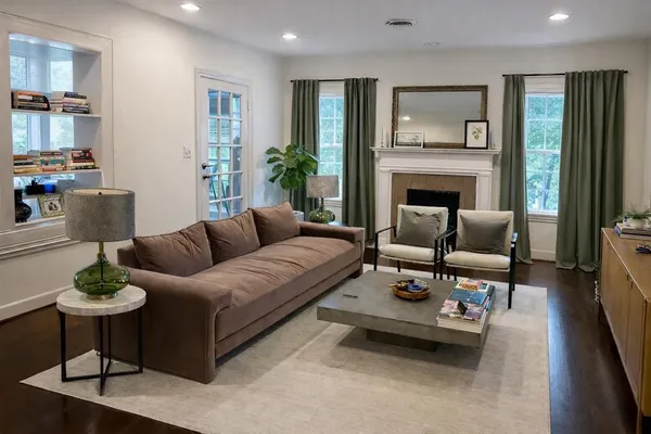 a living room with furniture and a fireplace