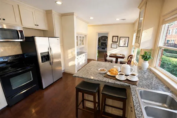 a kitchen with granite countertop stainless steel appliances and wooden cabinets