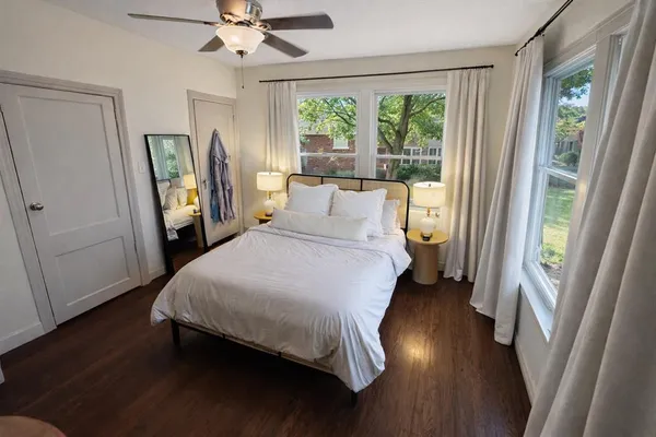 a bed sitting in a bedroom next to a window