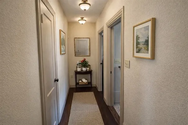 a view of a hallway with closet and a livingroom view