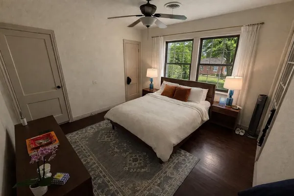 a bedroom with a bed and a large window