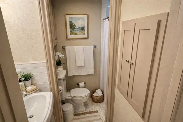 a bathroom with a toilet and a shower