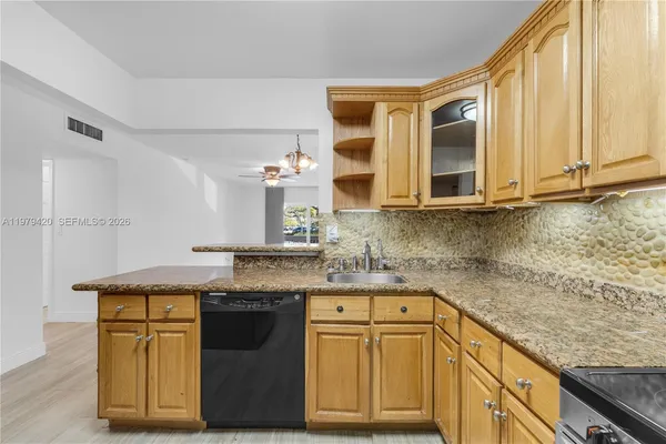 a kitchen with stainless steel appliances granite countertop a stove and a sink
