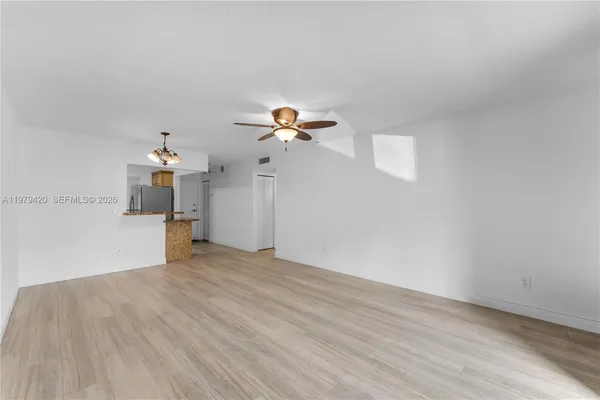 a view of a room with wooden floor