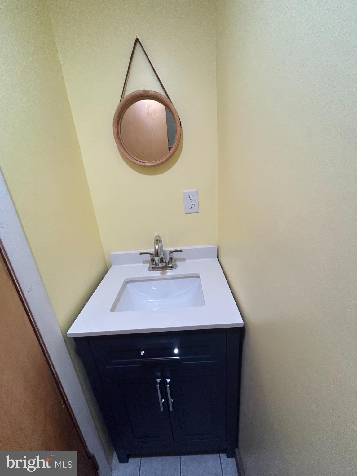 10830 Perrin Road Philadelphia, PA 19154 - Photo 17 of 25 a bathroom with a sink a mirror and vanity
