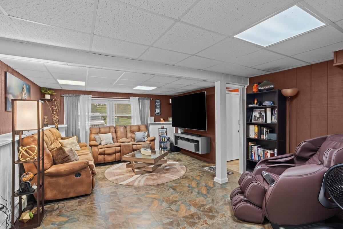3315 Aspen Road Kunkletown, PA 18058 - Photo 11 of 32 a living room with furniture a flat screen tv and a large window