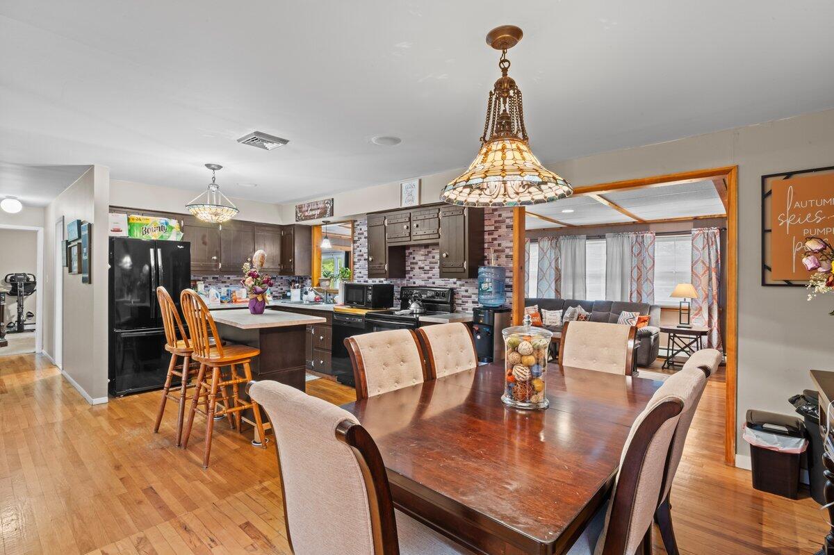 3315 Aspen Road Kunkletown, PA 18058 - Photo 16 of 32 a dining room with furniture a chandelier and wooden floor