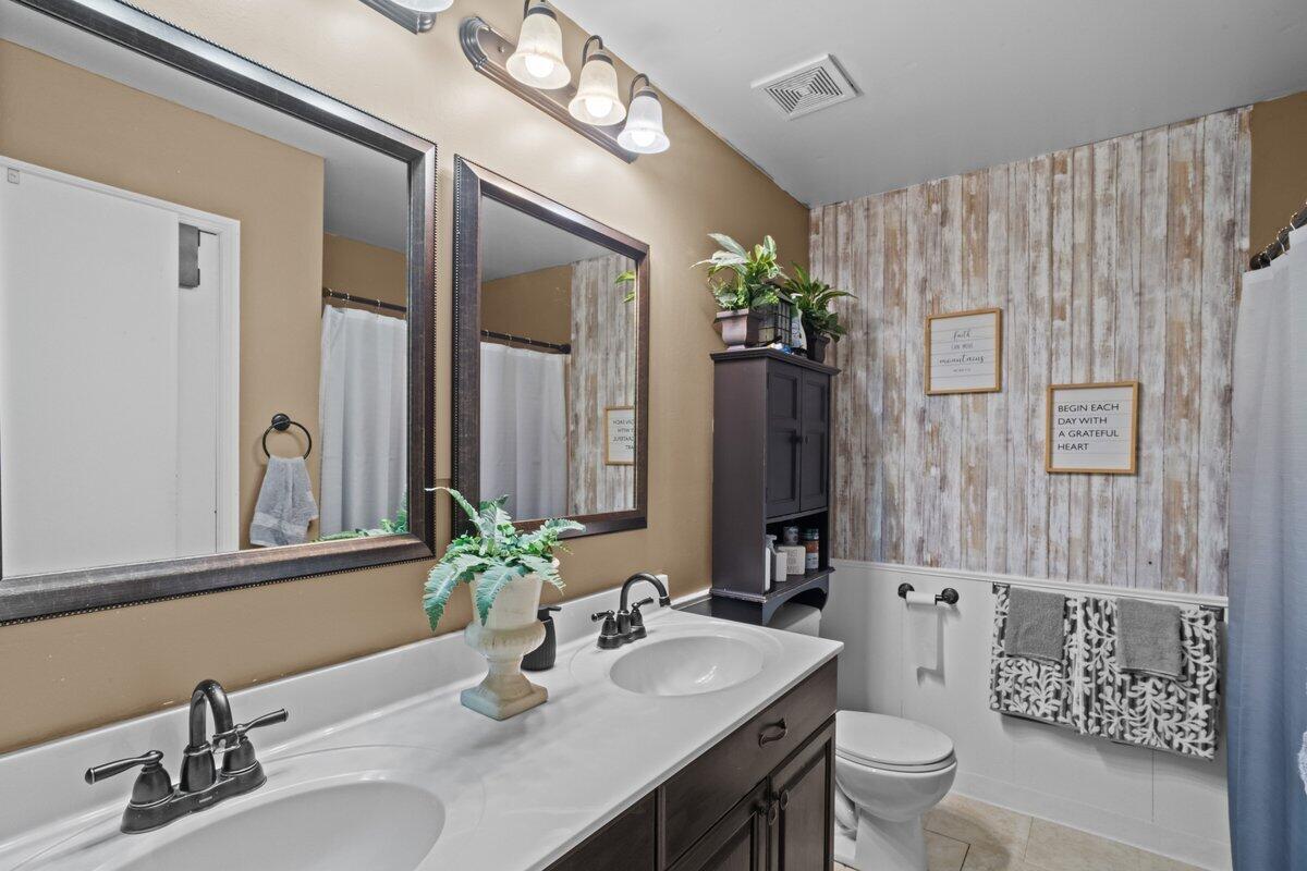 3315 Aspen Road Kunkletown, PA 18058 - Photo 32 of 32 a bathroom with double vanity sinks a toilet a mirror and shower