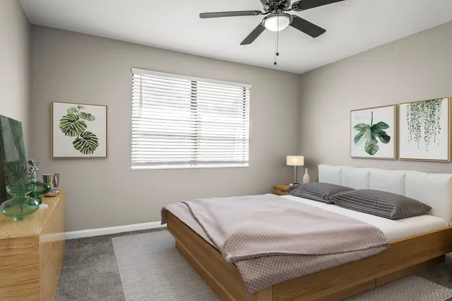 a bedroom with a bed and a window