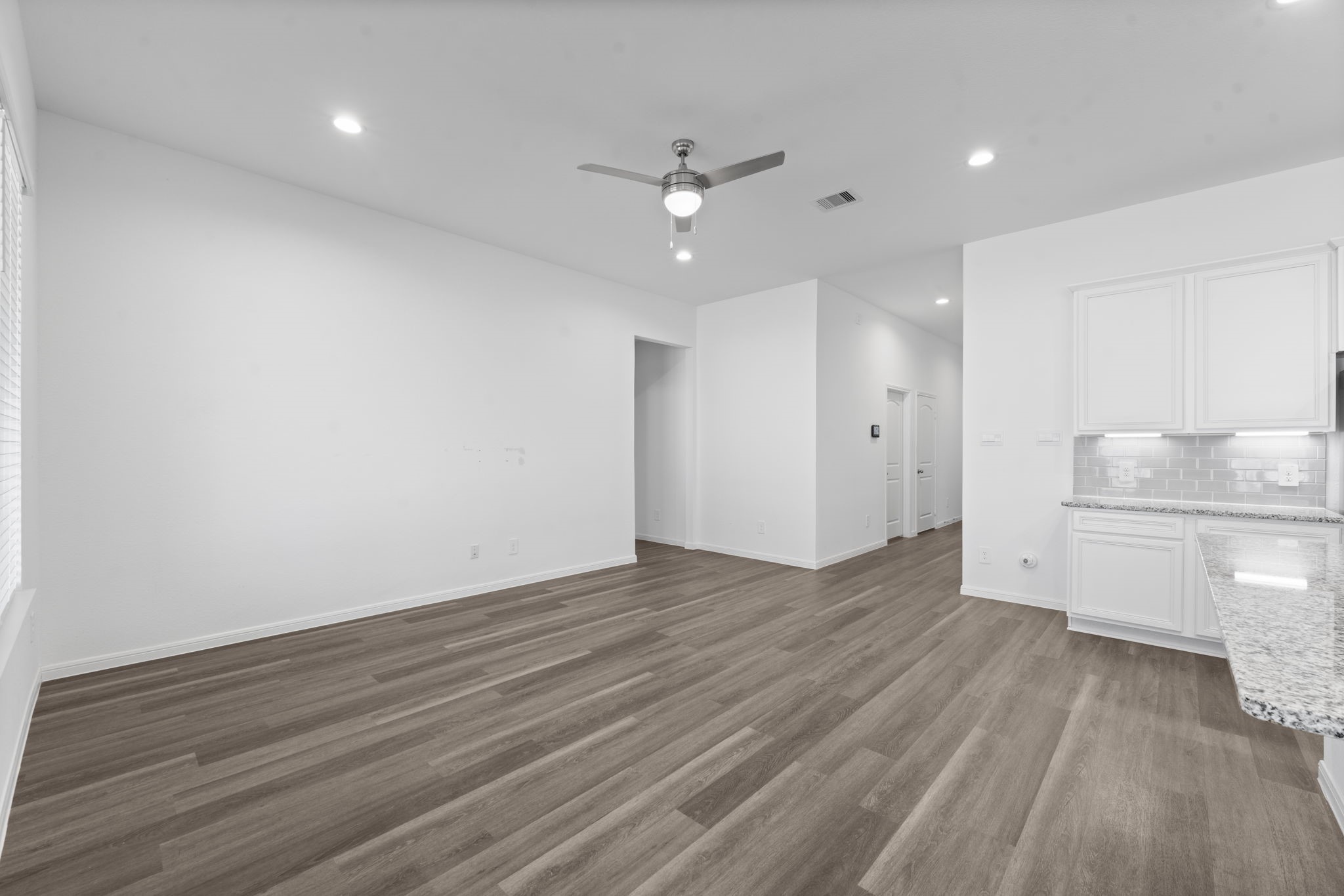 544 Newcomb Hollow Drive Conroe, TX 77304 - Photo 11 of 31 View of the living room. The primary suite is located on the left.