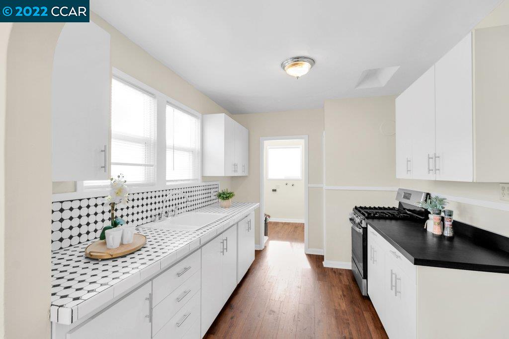 Undisclosed Address Richmond, CA 94801 - Photo 15 of 34 a kitchen with a sink and cabinets