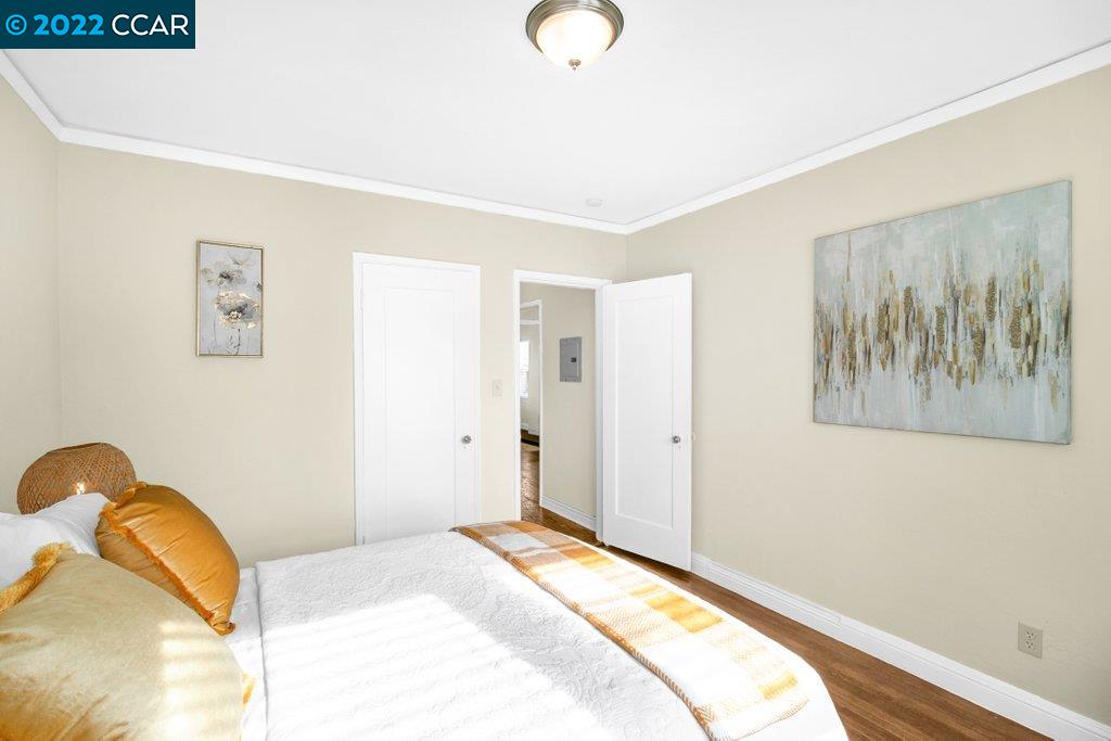 Undisclosed Address Richmond, CA 94801 - Photo 18 of 34 a bedroom with a bed and a painting on the wall