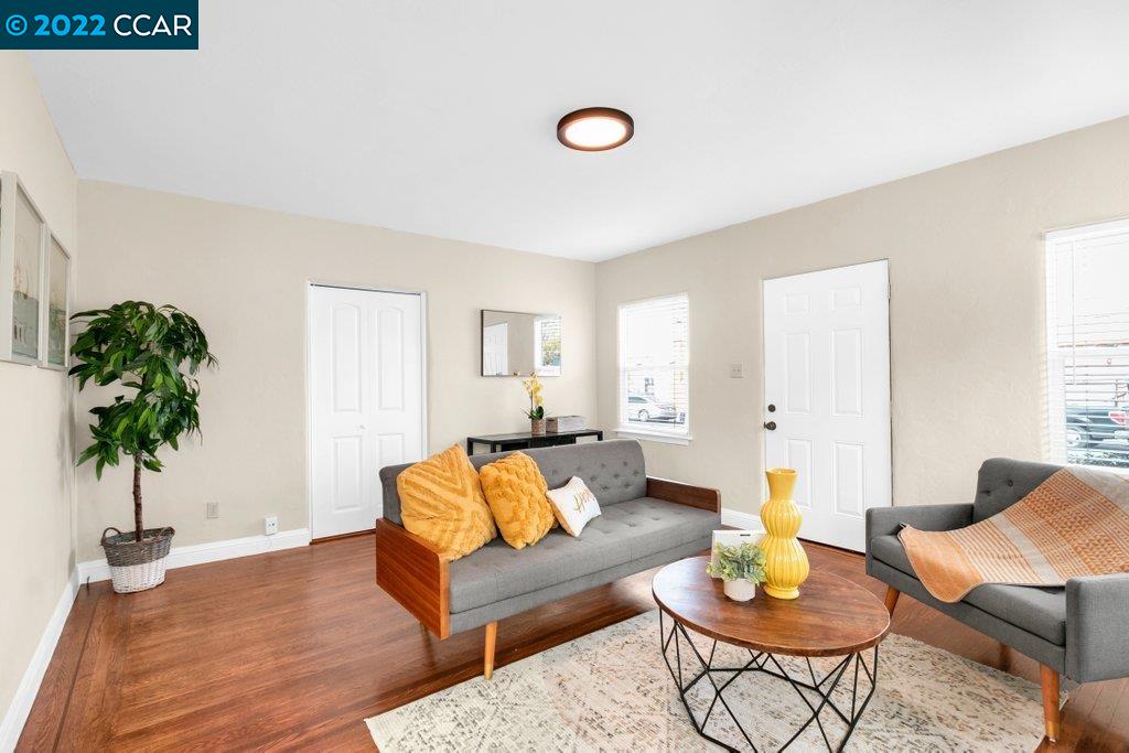 Undisclosed Address Richmond, CA 94801 - Photo 2 of 34 a living room with furniture and a potted plant