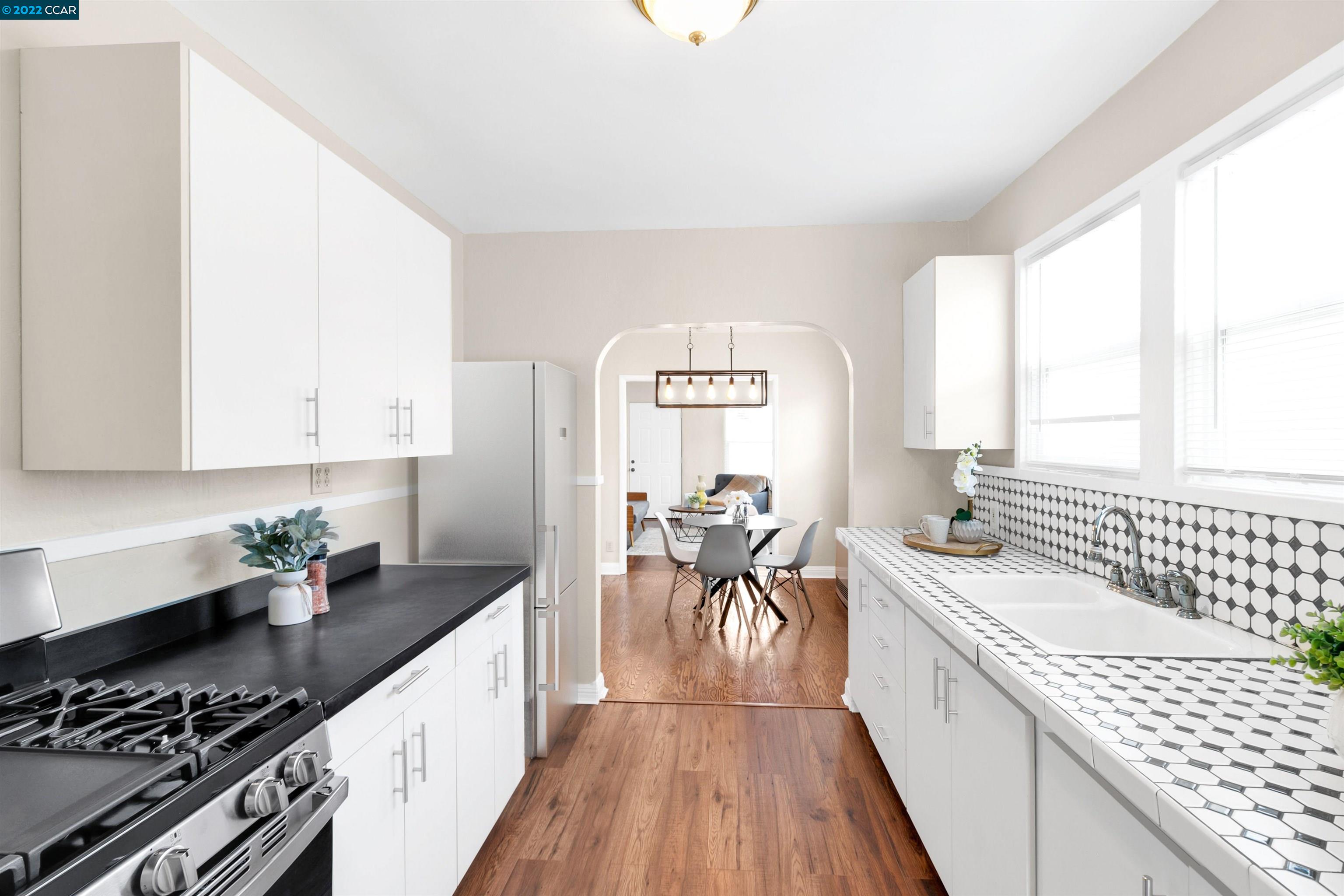 Undisclosed Address Richmond, CA 94801 - Photo 9 of 34 a kitchen with a sink stove and cabinets