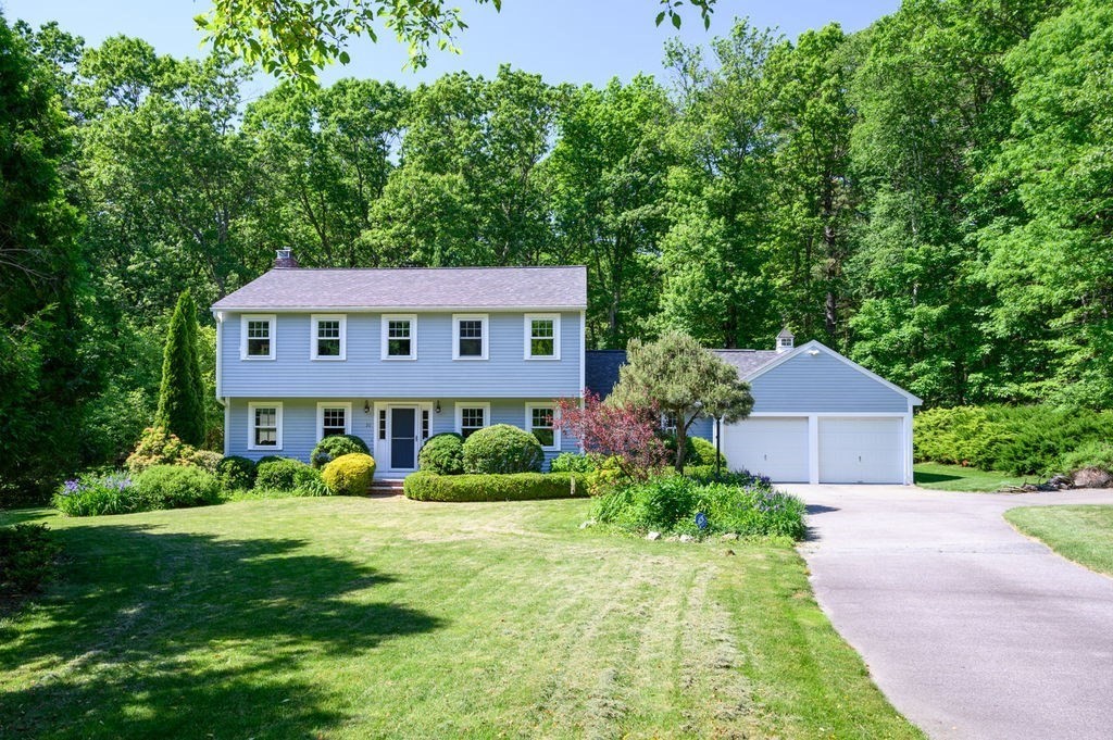 a aerial view of a house next to a big yard and large trees