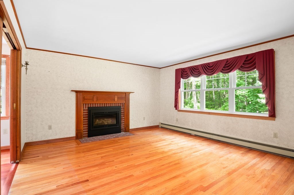 20 Longbrook Road Newbury, MA 01922 - Photo 4 of 41 an empty room with a fireplace and windows