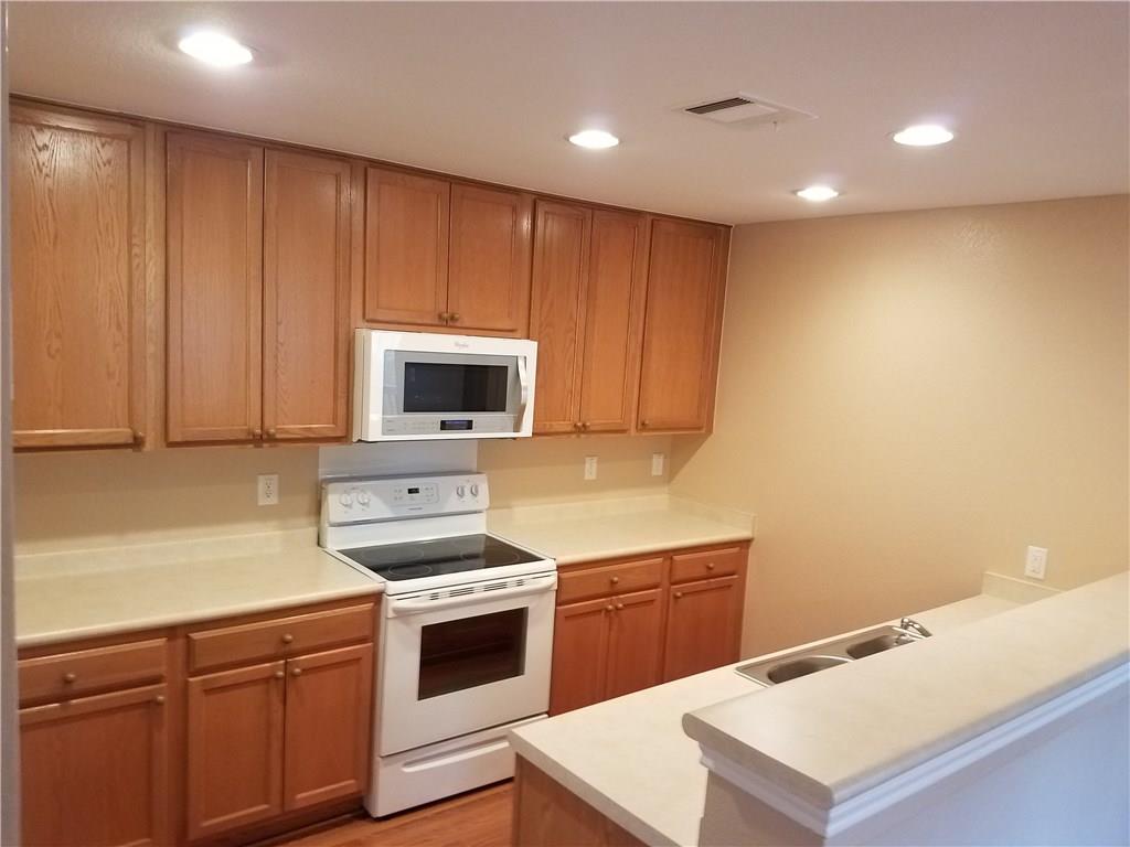 273 Tower Drive Kyle, TX 78640 - Photo 5 of 13 a kitchen with a sink cabinets and stainless steel appliances